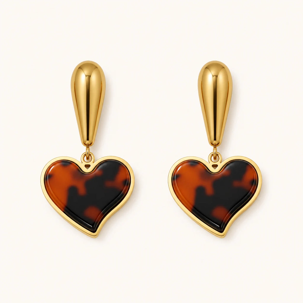 Heart-shaped tortoiseshell earrings with gold accents on a white background