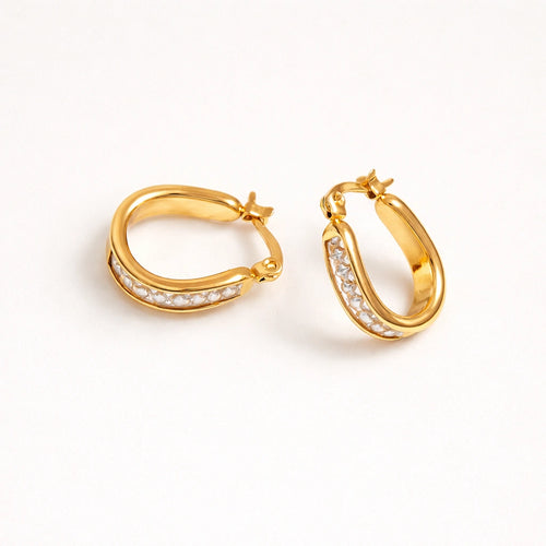 Gold hoop earrings with embedded stones on a white background
