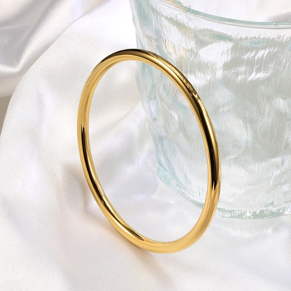 Gold ring on a white fabric background